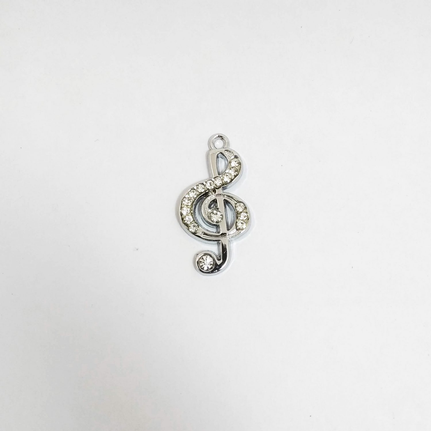 Dije c/strass metal niquelado clave sol