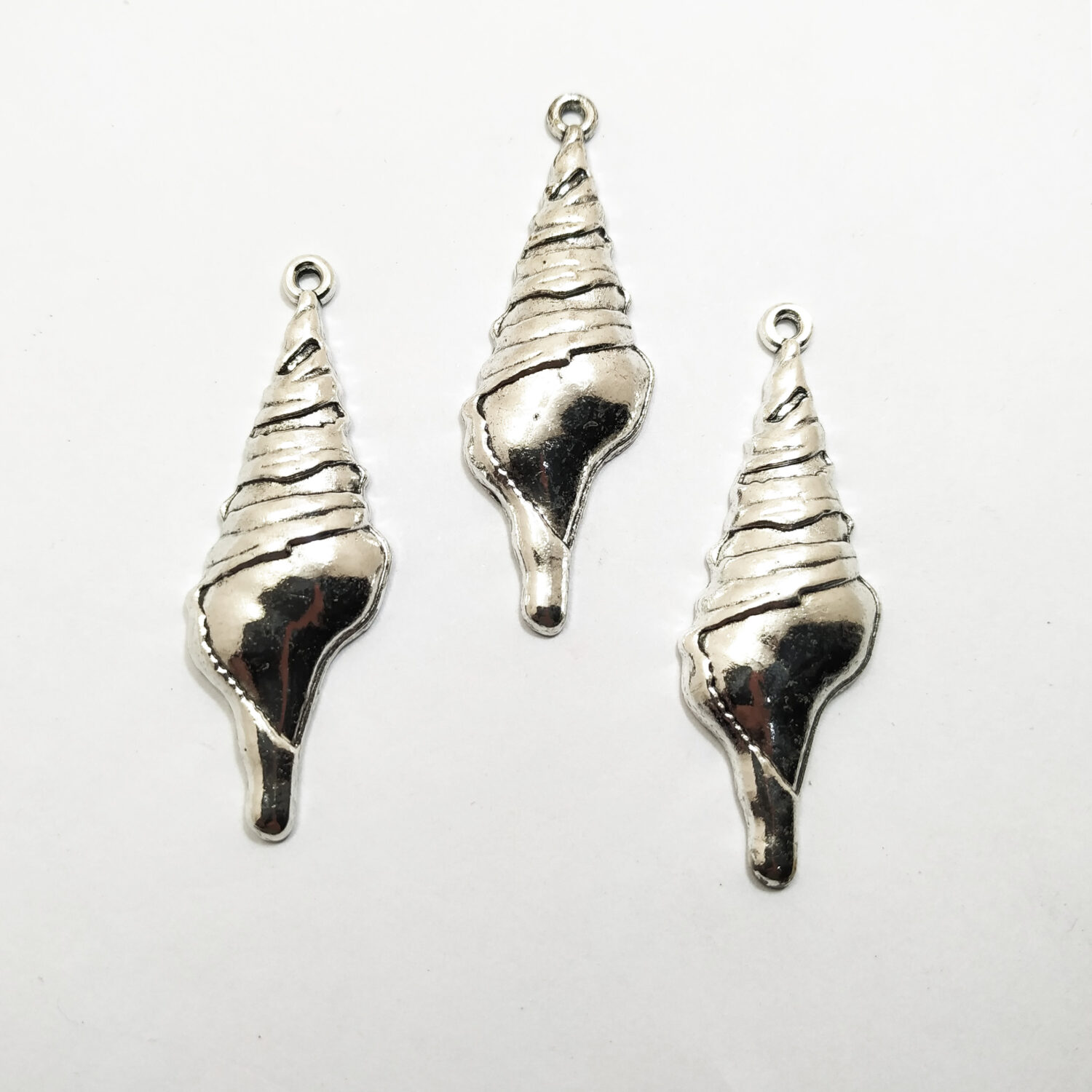 Dije metal niquel caracol grande x1