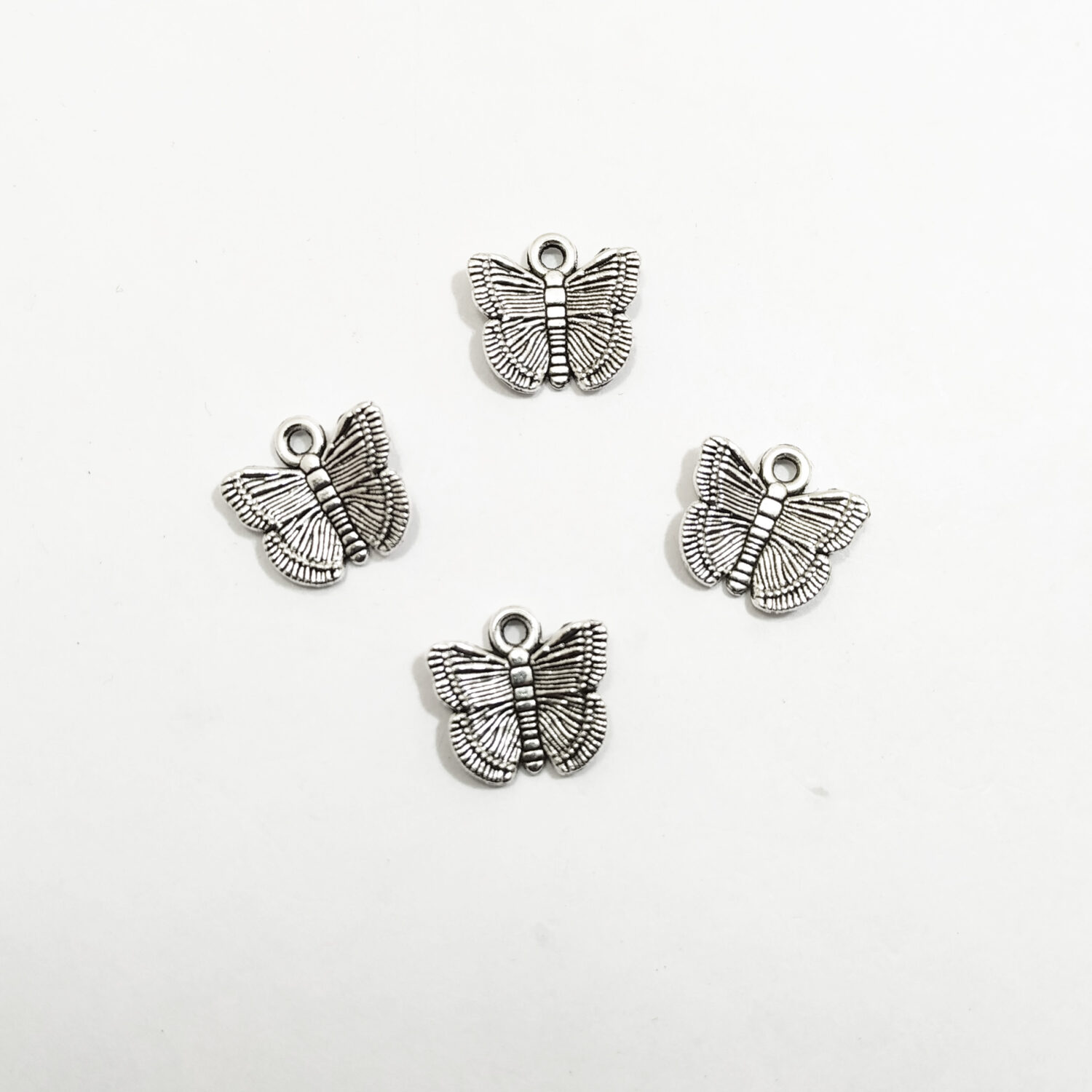 Dije metal mariposa niquel x10u